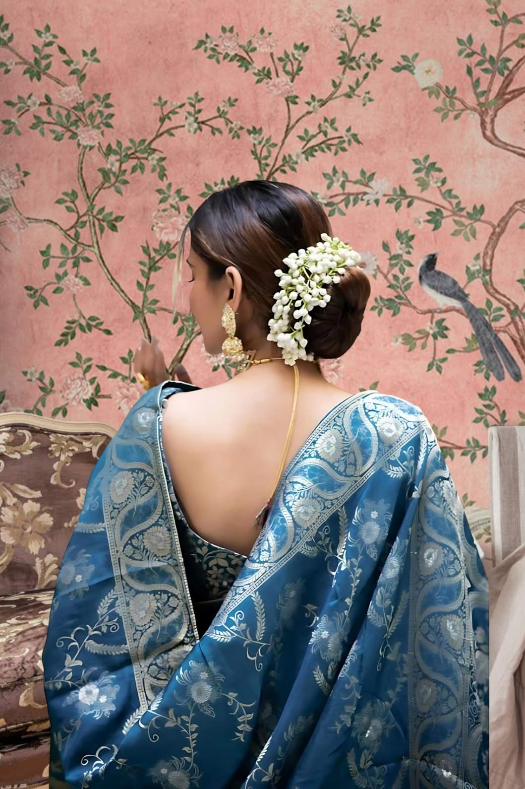 Rear angle highlighting embellished pallu in mint-toned luxury