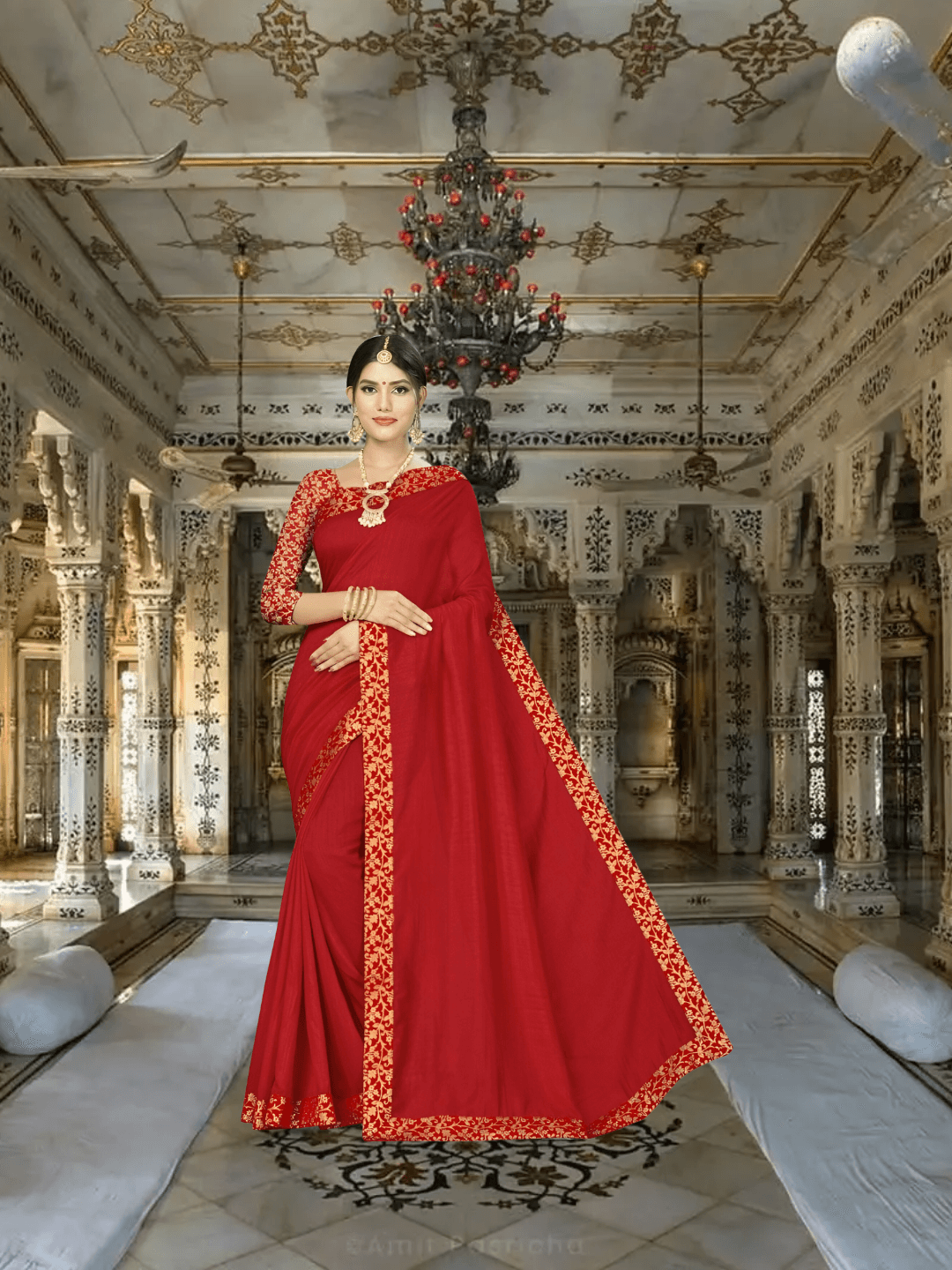 Model in sindoor red silk blend saree with golden patterns inside palace