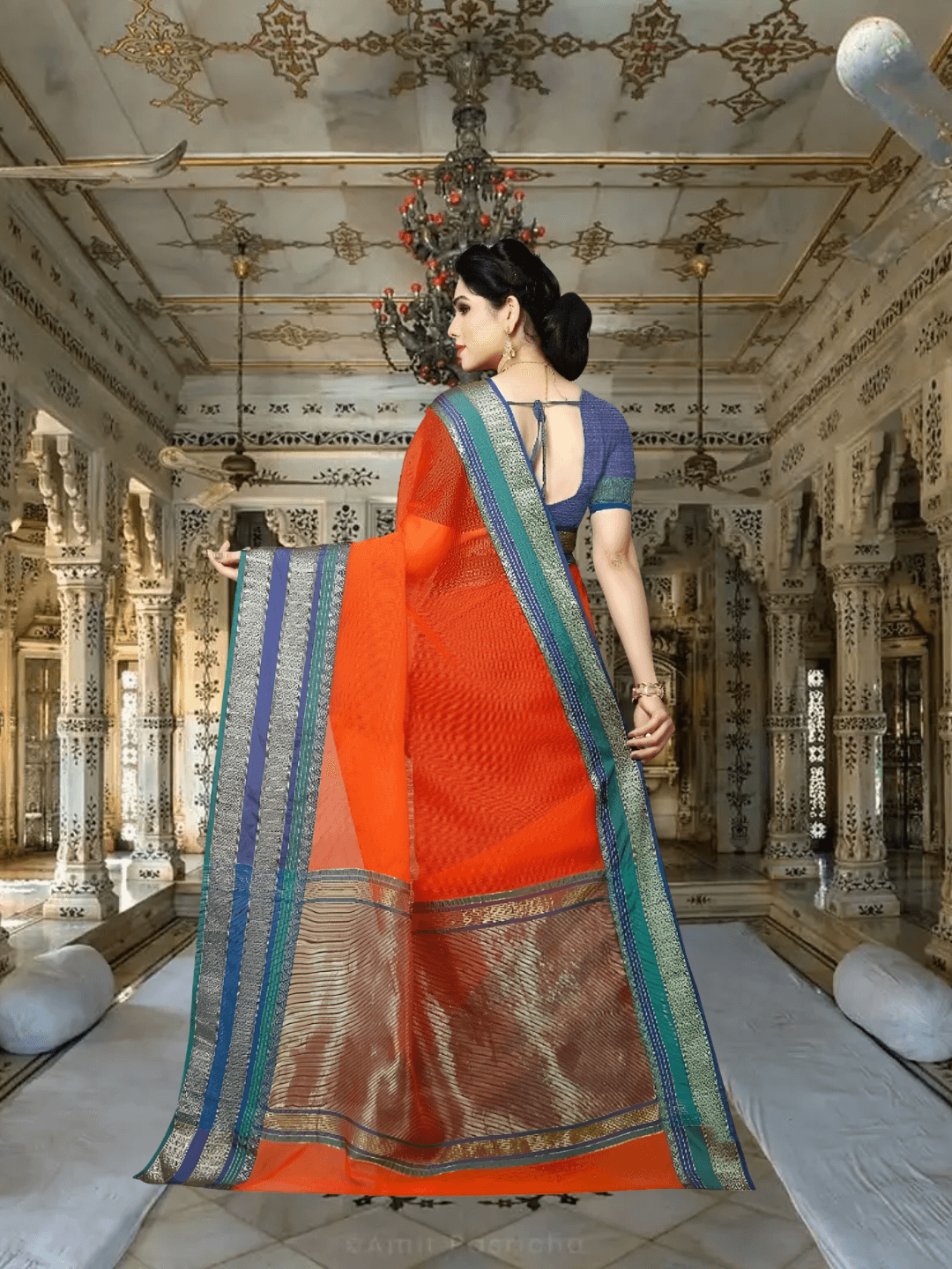Model with back toward lens, pleats fanned gracefully with ornate tri-color border