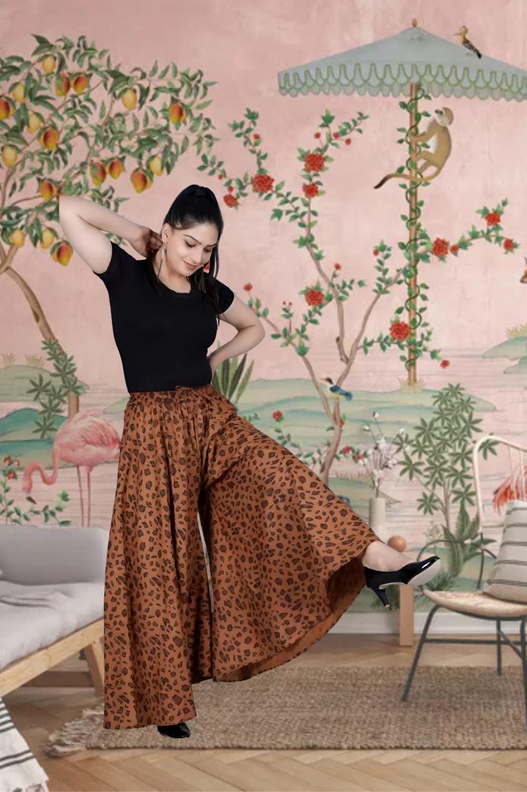 Front view of brown jaguar print palazzo pants in palace setting