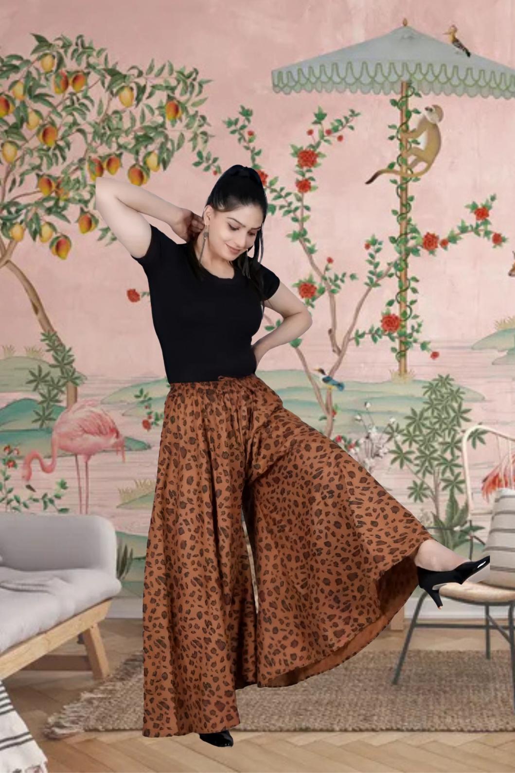 Front view of brown jaguar print palazzo pants in palace setting