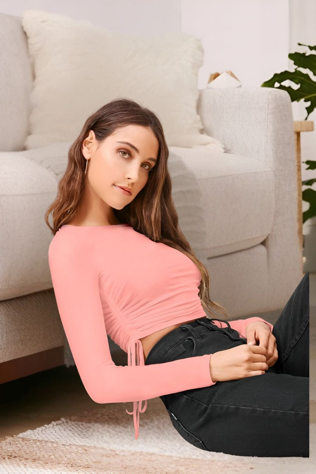 Left profile of peach full sleeve top in elegant setting