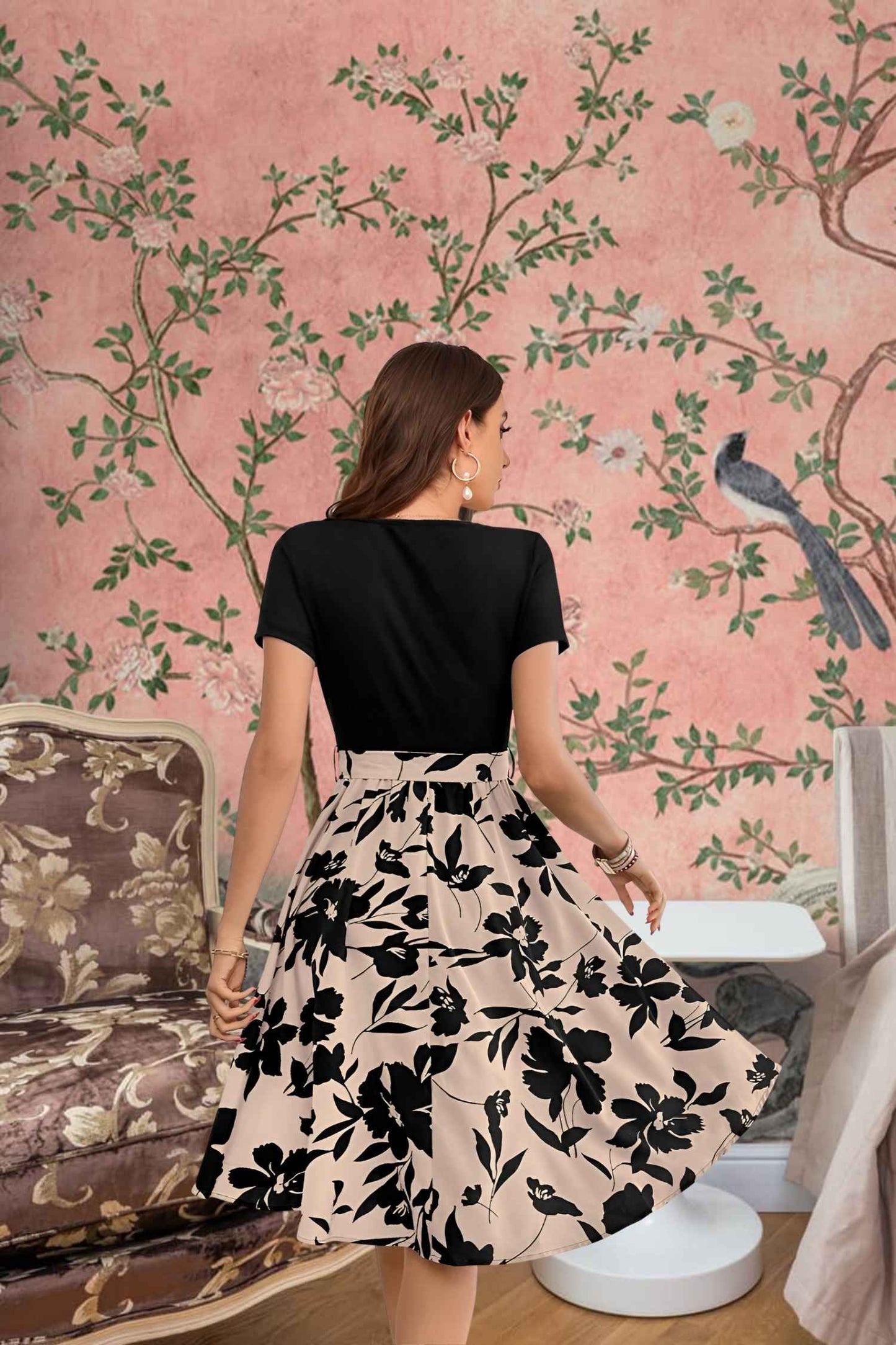 Back angle showing full flow of cream floral skirt with fitted black top