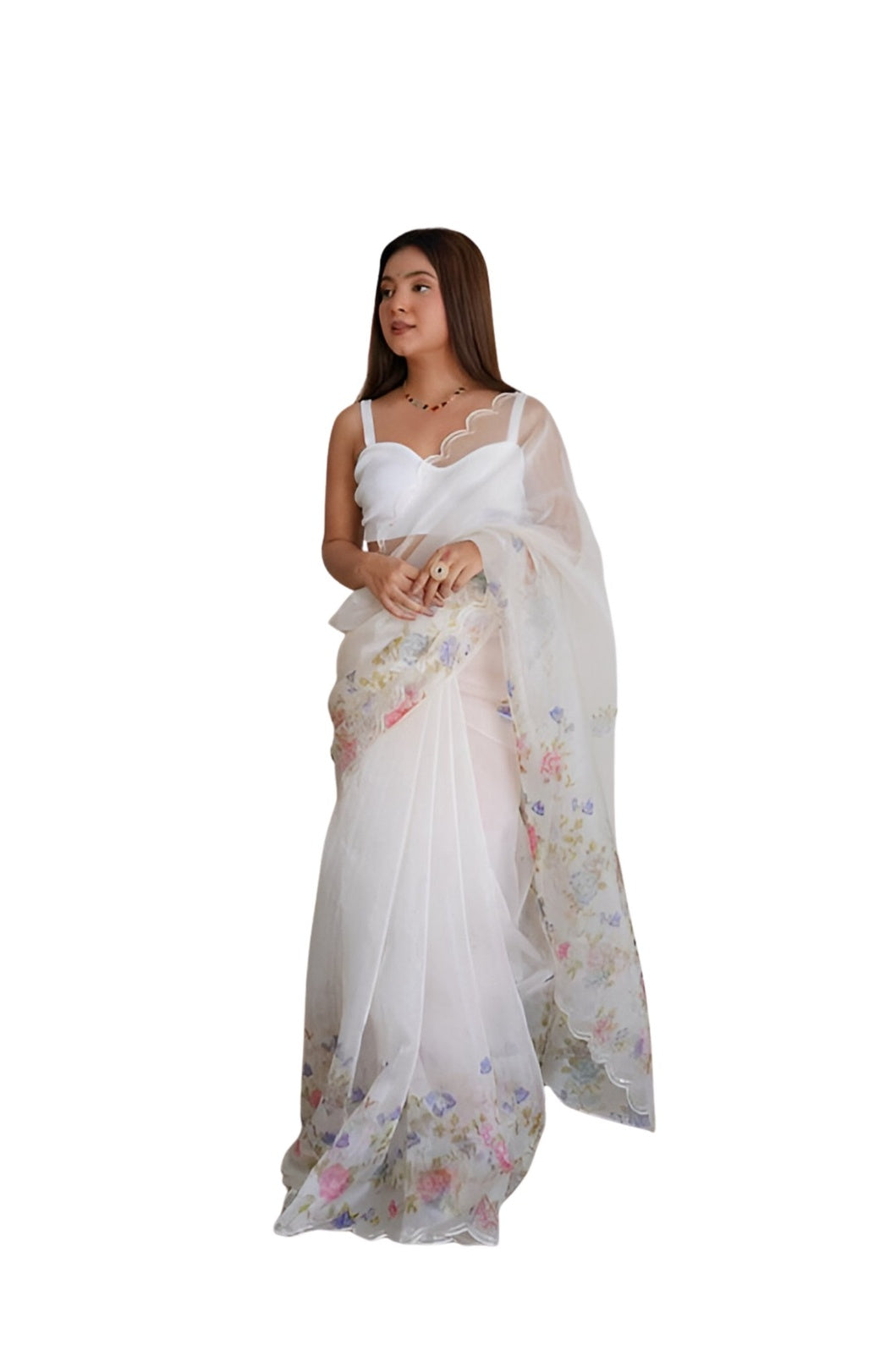 Studio shot of model standing in classic organza saree pose
