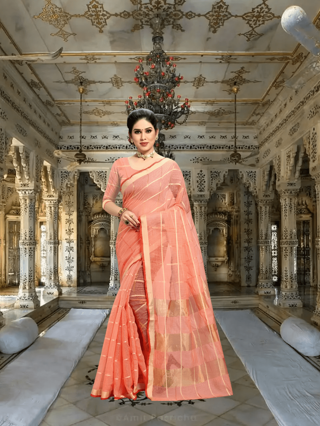 Side drape showing airy pallu in soft peach cotton, gold lines catching the studio light