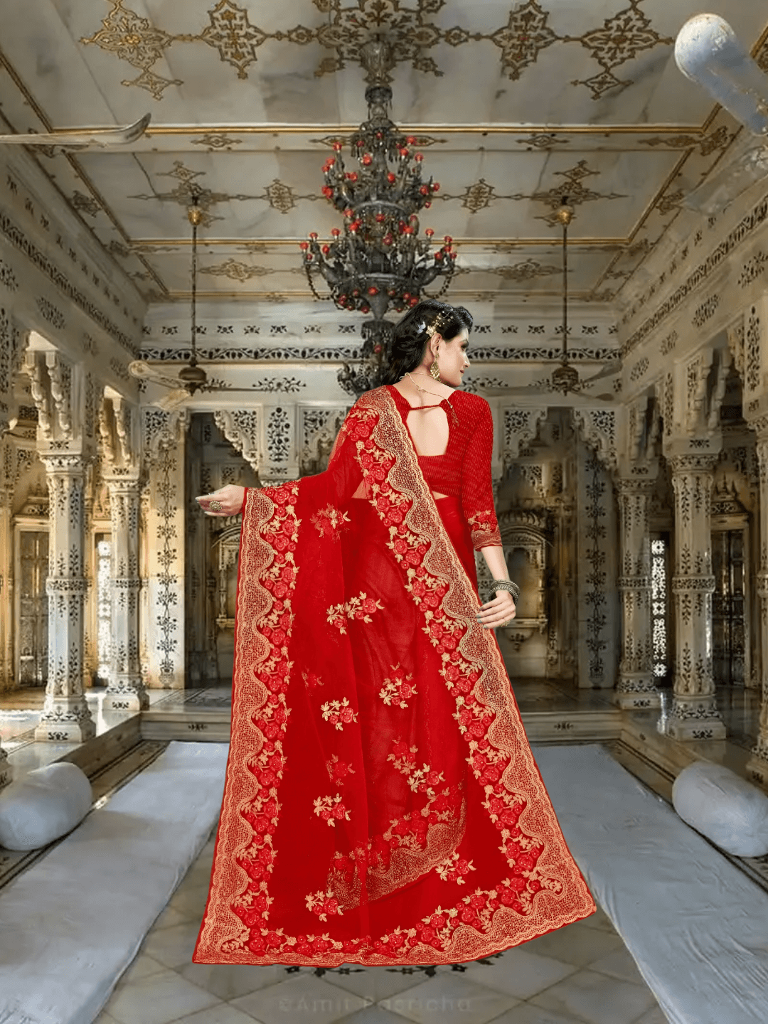 Backlit shot with saree flaring like a scarlet halo, gold thread glowing like embers