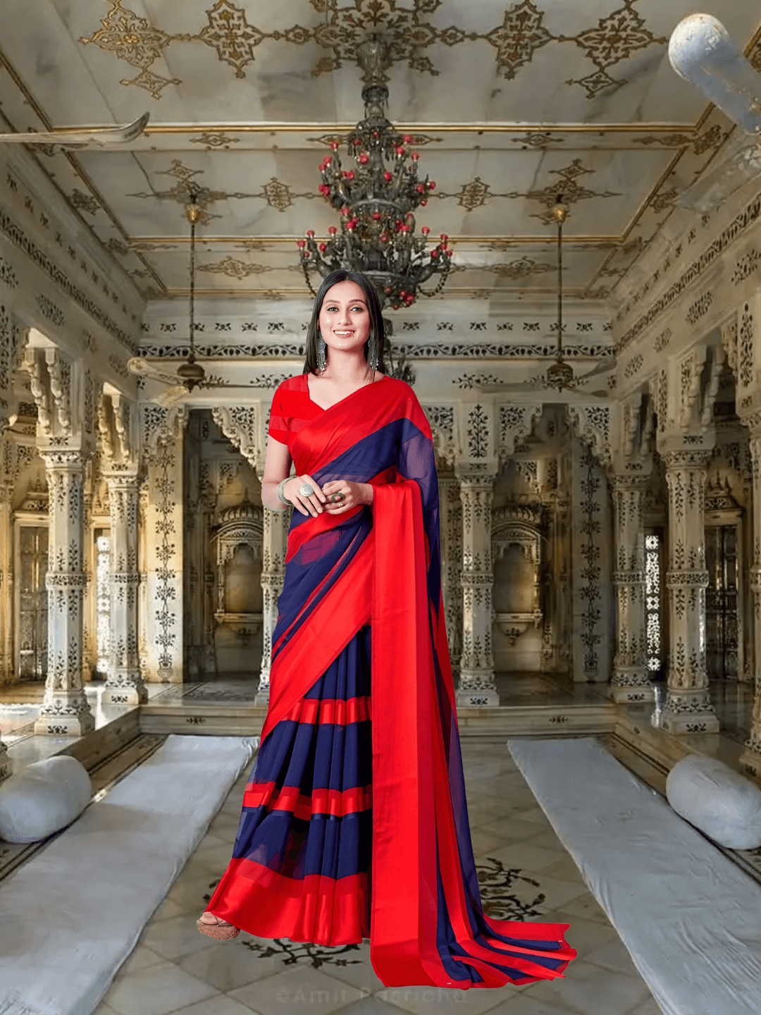 Model twirling red-to-navy solid saree at palace