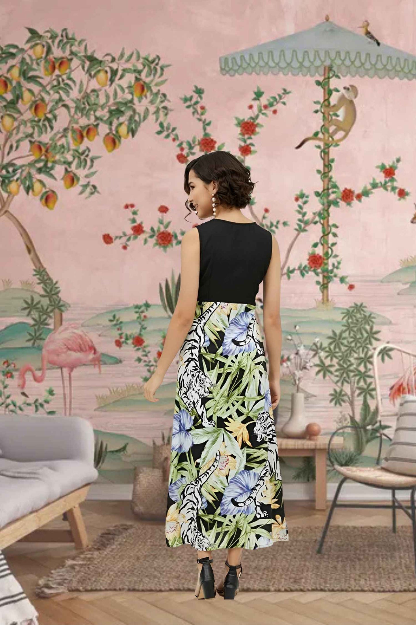 Back angle of the dress capturing the full floral explosion from midnight black to multicolor blooms