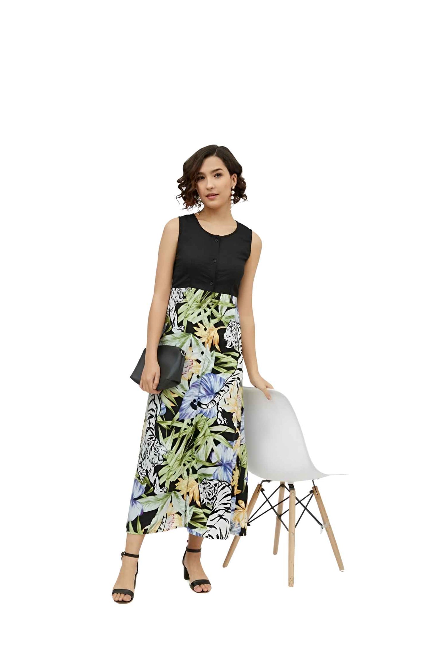 Sleeveless black-and-floral dress isolated on white, highlighting the dramatic color contrast