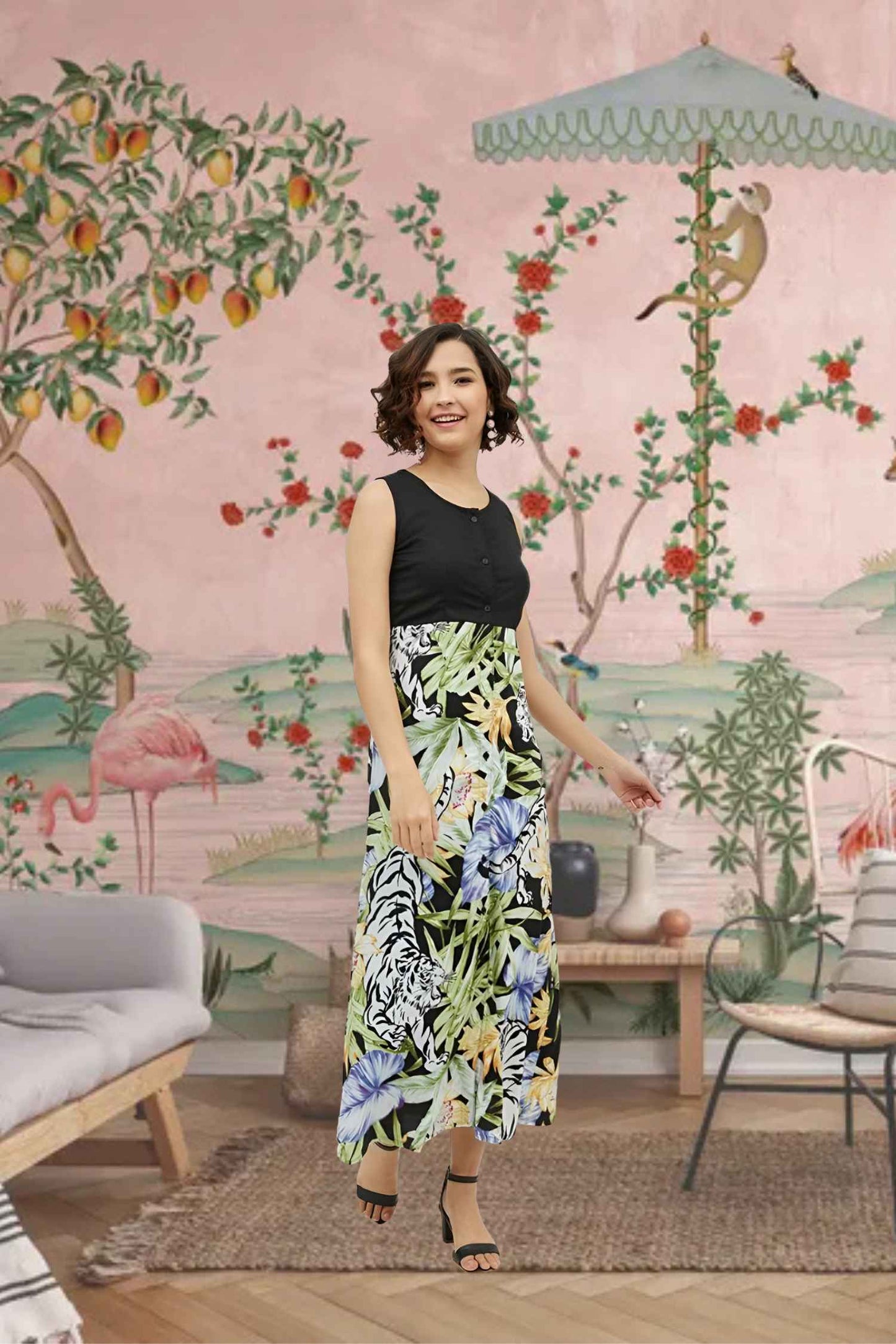 Front view of the Eventide Sonnet dress showing black bodice melting into dawn-colored florals, modeled against a fading sunset