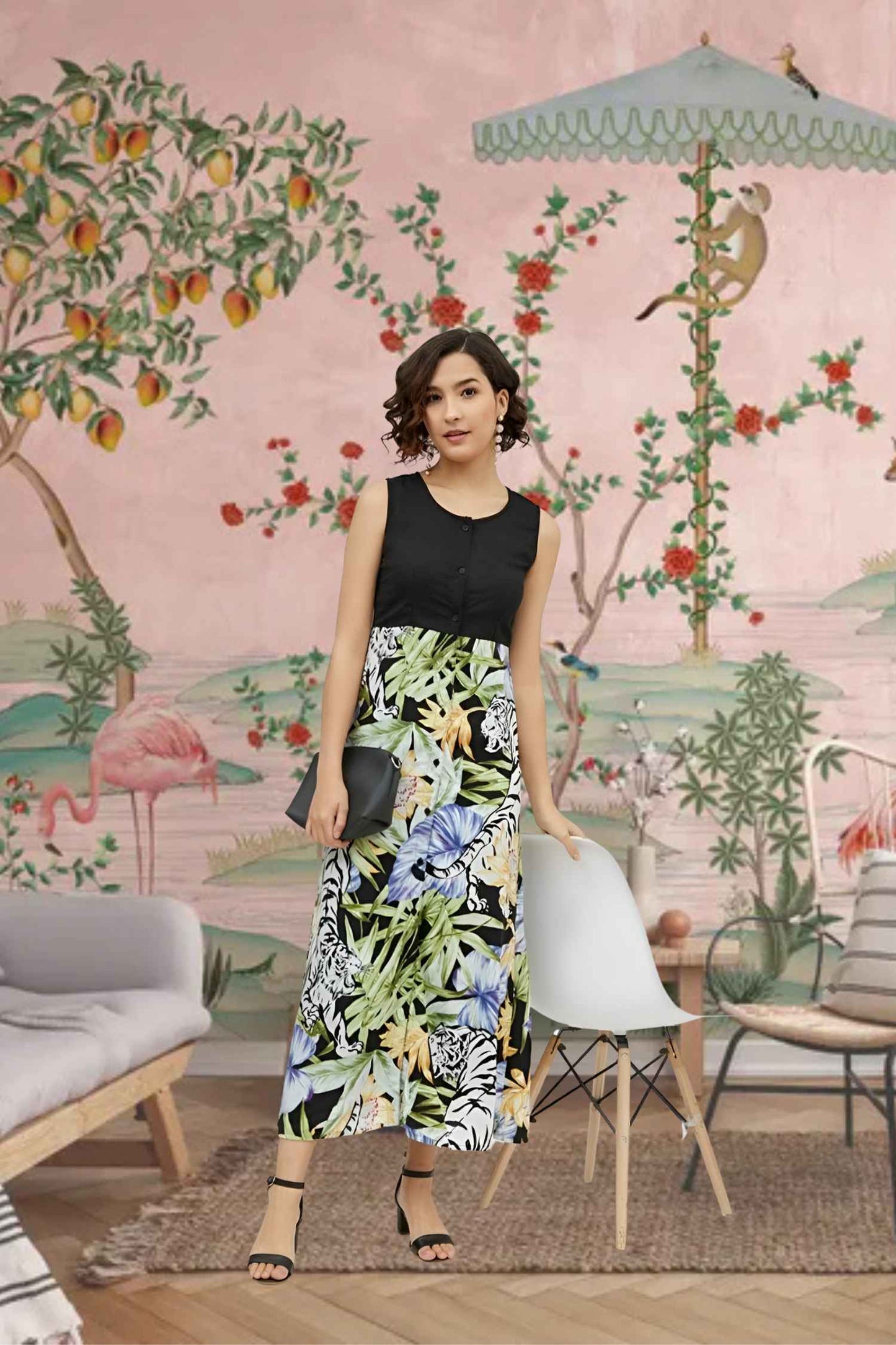 Front view of the Eventide Sonnet dress showing black bodice melting into dawn-colored florals, modeled against a fading sunset