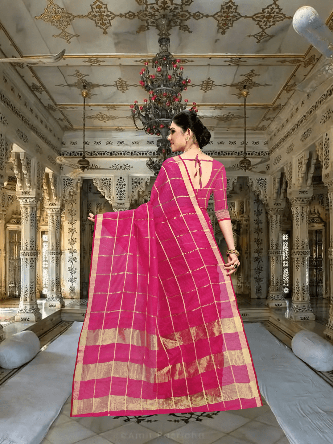 Rear pose with open pallu, red blouse creating bold contrast with soft pink body of the saree