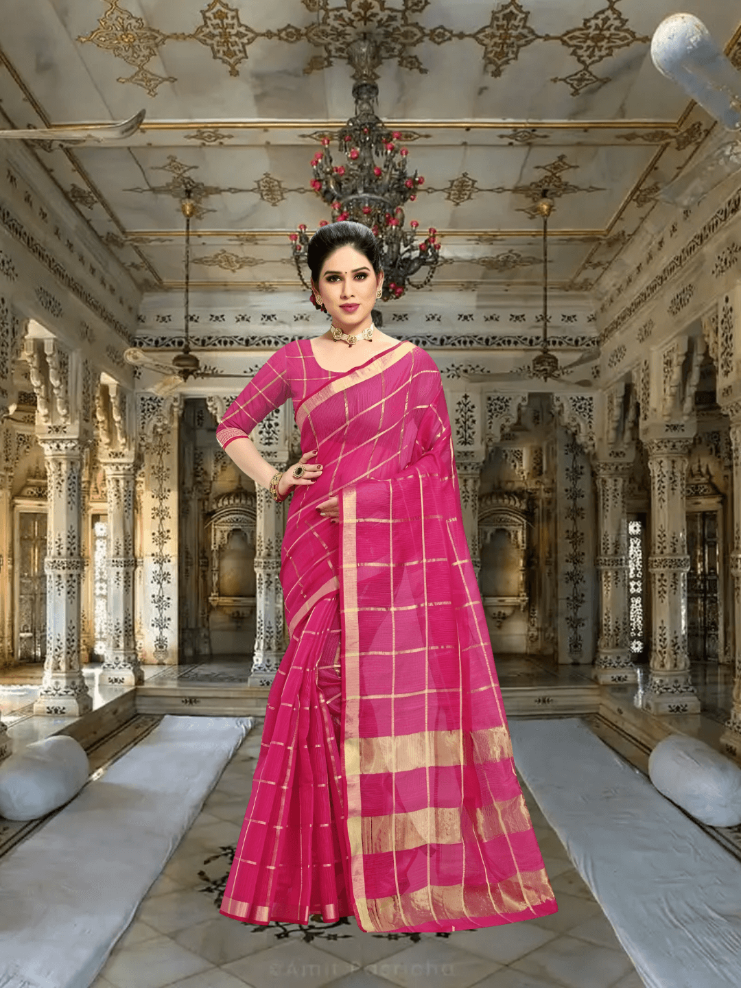Model walking past heritage columns, saree flowing like prayer in motion, checkered pink gleaming under sunrays