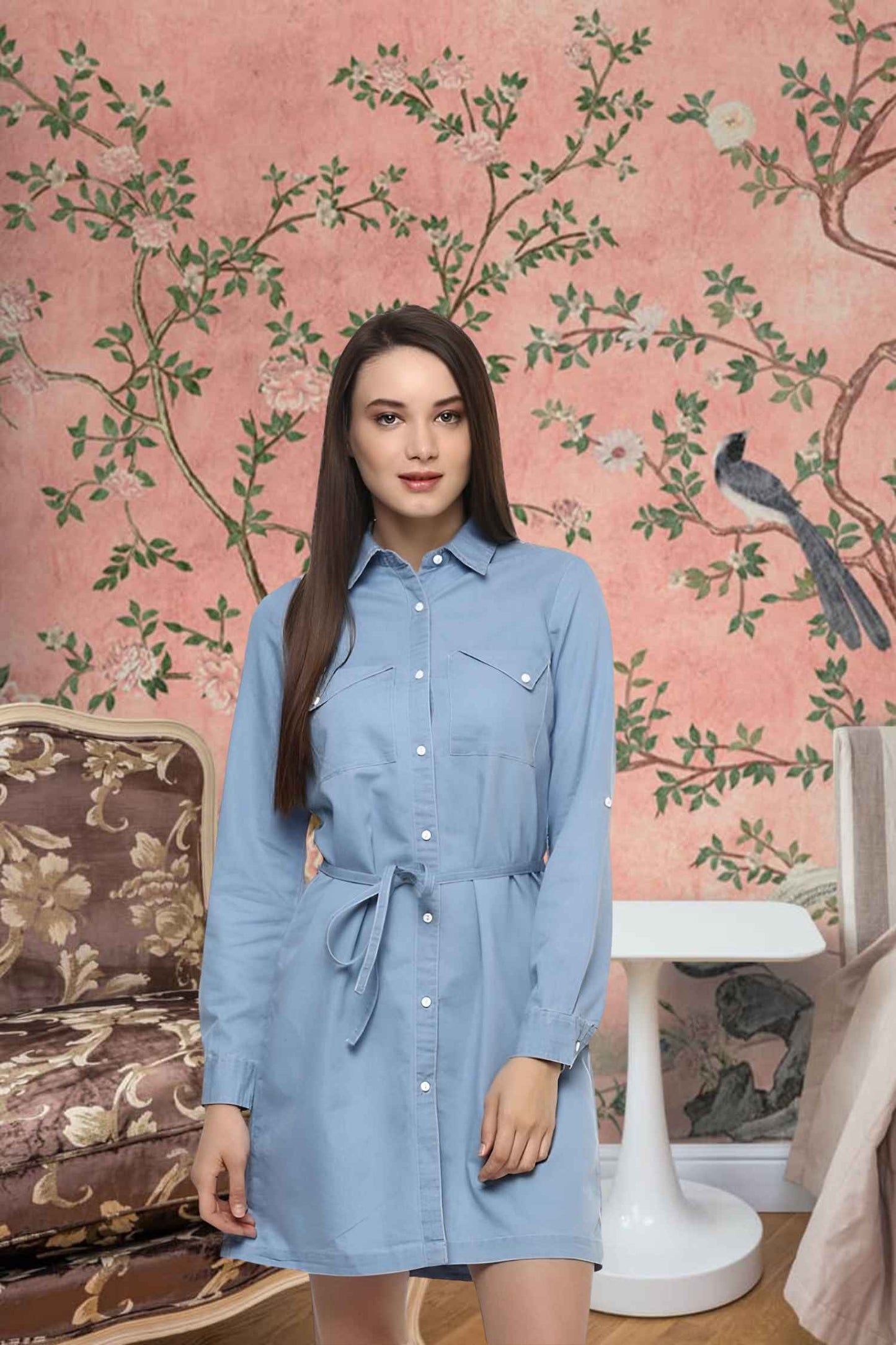 Front view of blue denim dress with rolled sleeves against wooden pier