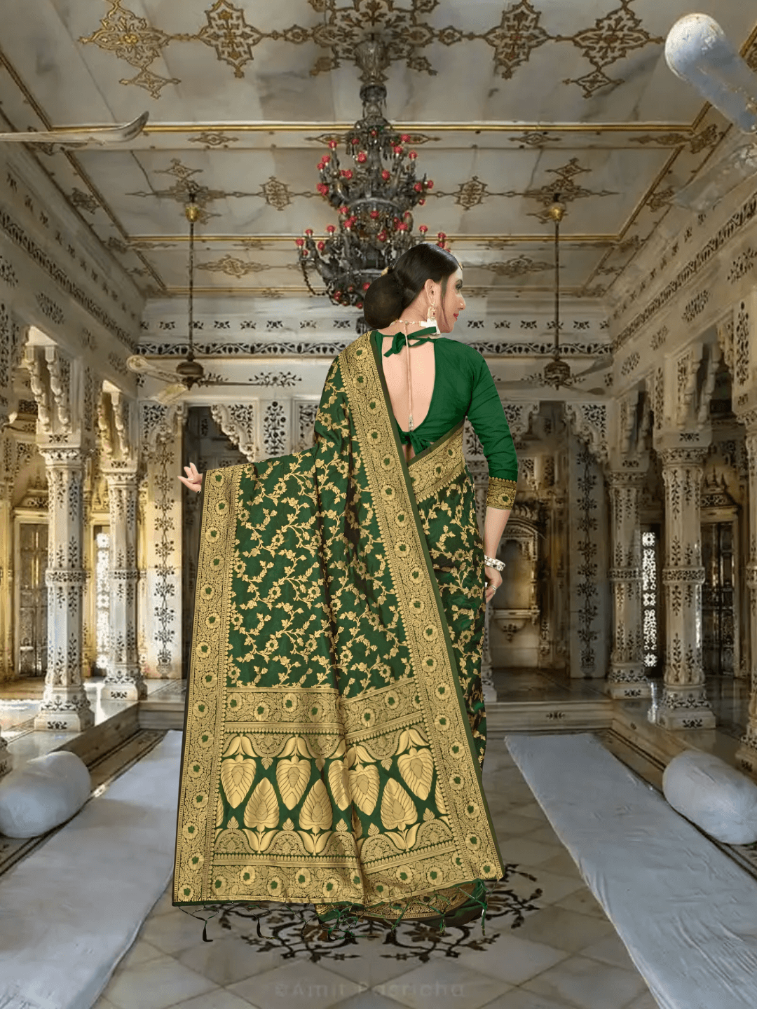 Golden zari pallu cascading on deep green silk in palace backdrop
