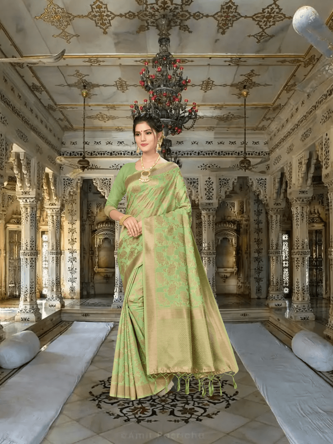 Close-up of golden borders on pista green handloom saree in palace backdrop