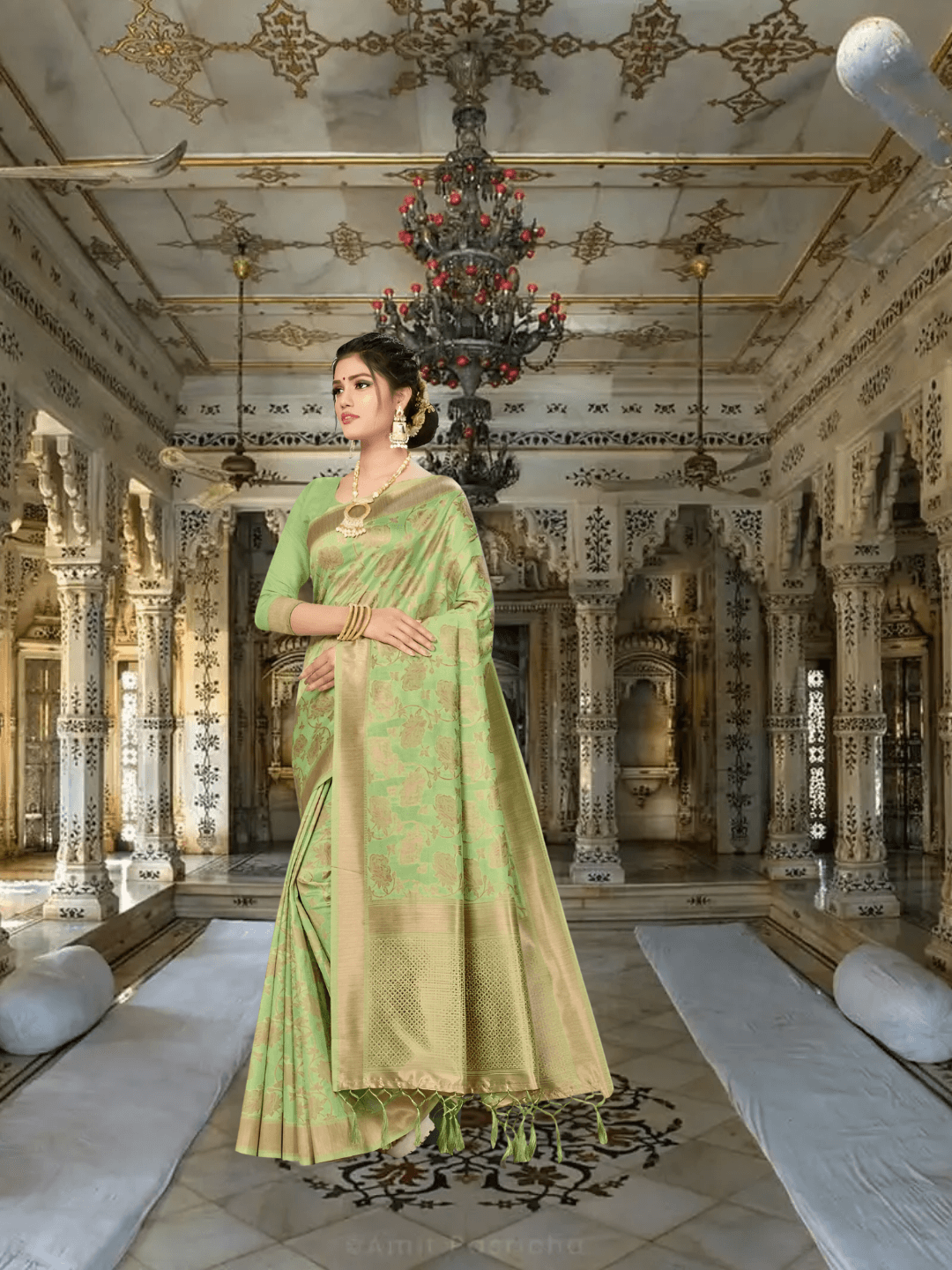 Model in pista green Banarasi cotton saree with gold borders standing in palace room