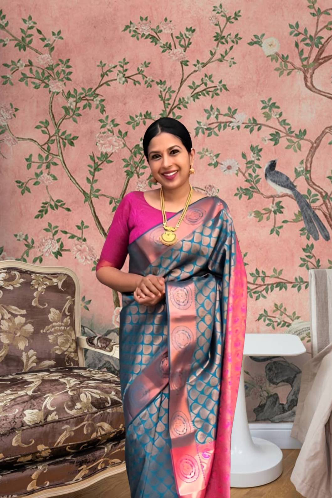 Front view of blue-green printed Litchi silk saree with pink blouse in palace setting