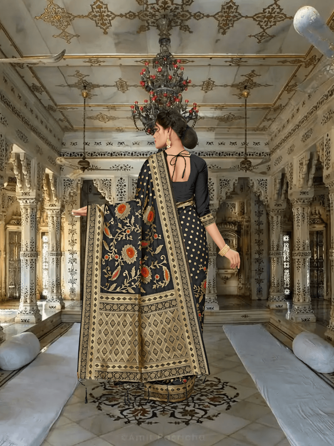 Black saree with gold zari pallu flowing in royal interior backdrop