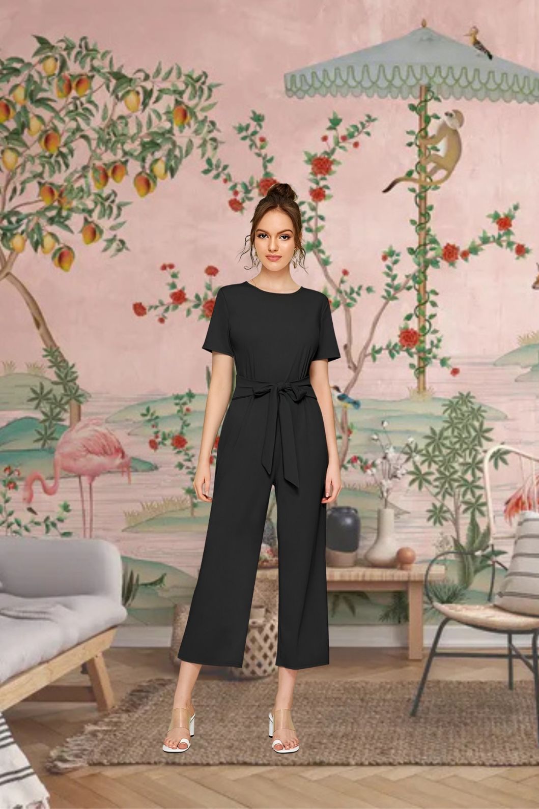 Front angle of black knitted cap sleeve jumpsuit with round neck – lifestyle background