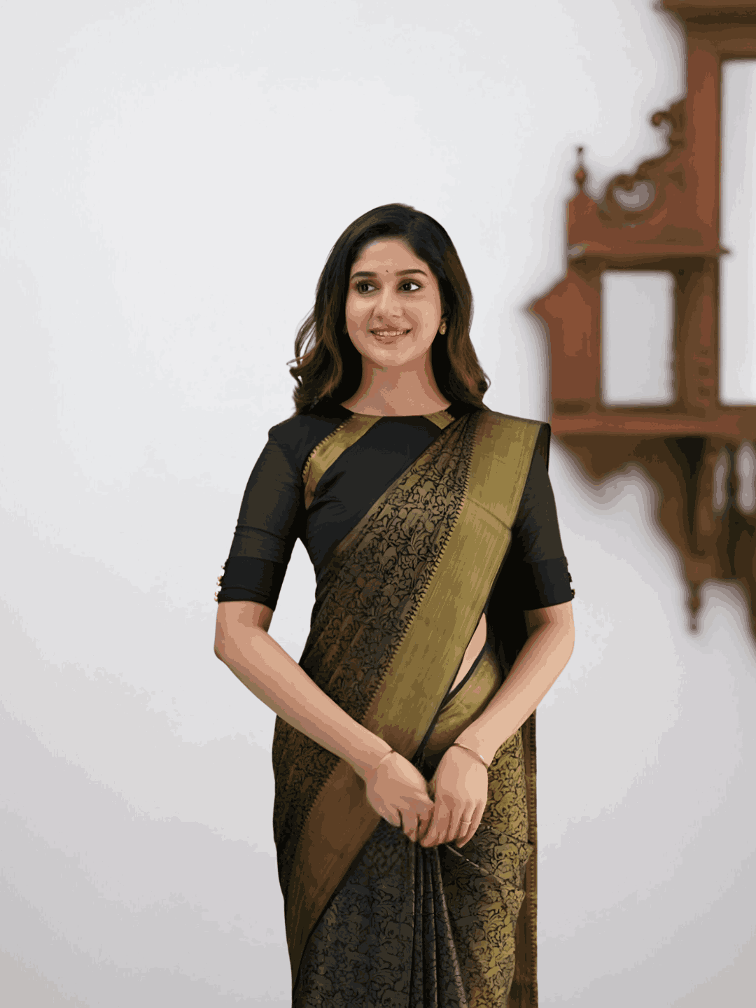 Model in dramatic pose, black silk cascading with printed details