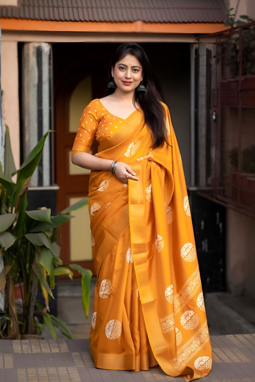 Studio front view of yellow saree showing print and elegant shape