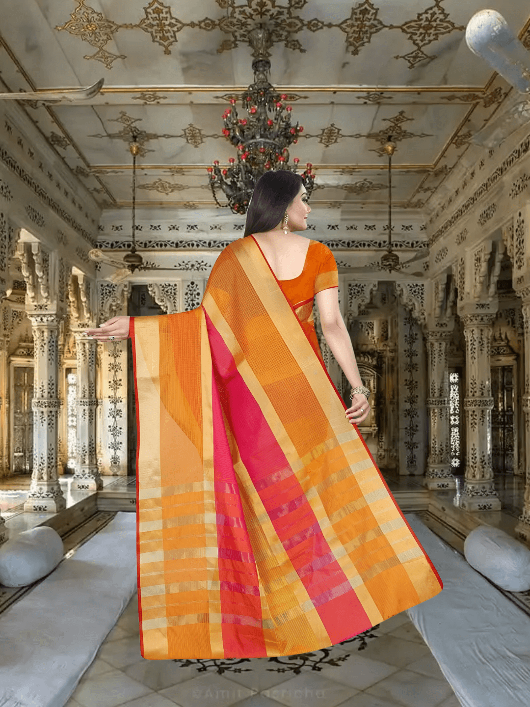 Movement shot capturing pallu in the air, gold border gleaming with contrast