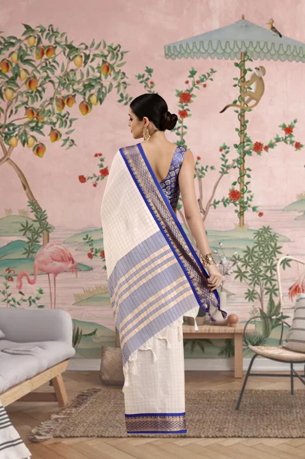Rear view showcasing deep blue pallu with golden border.
