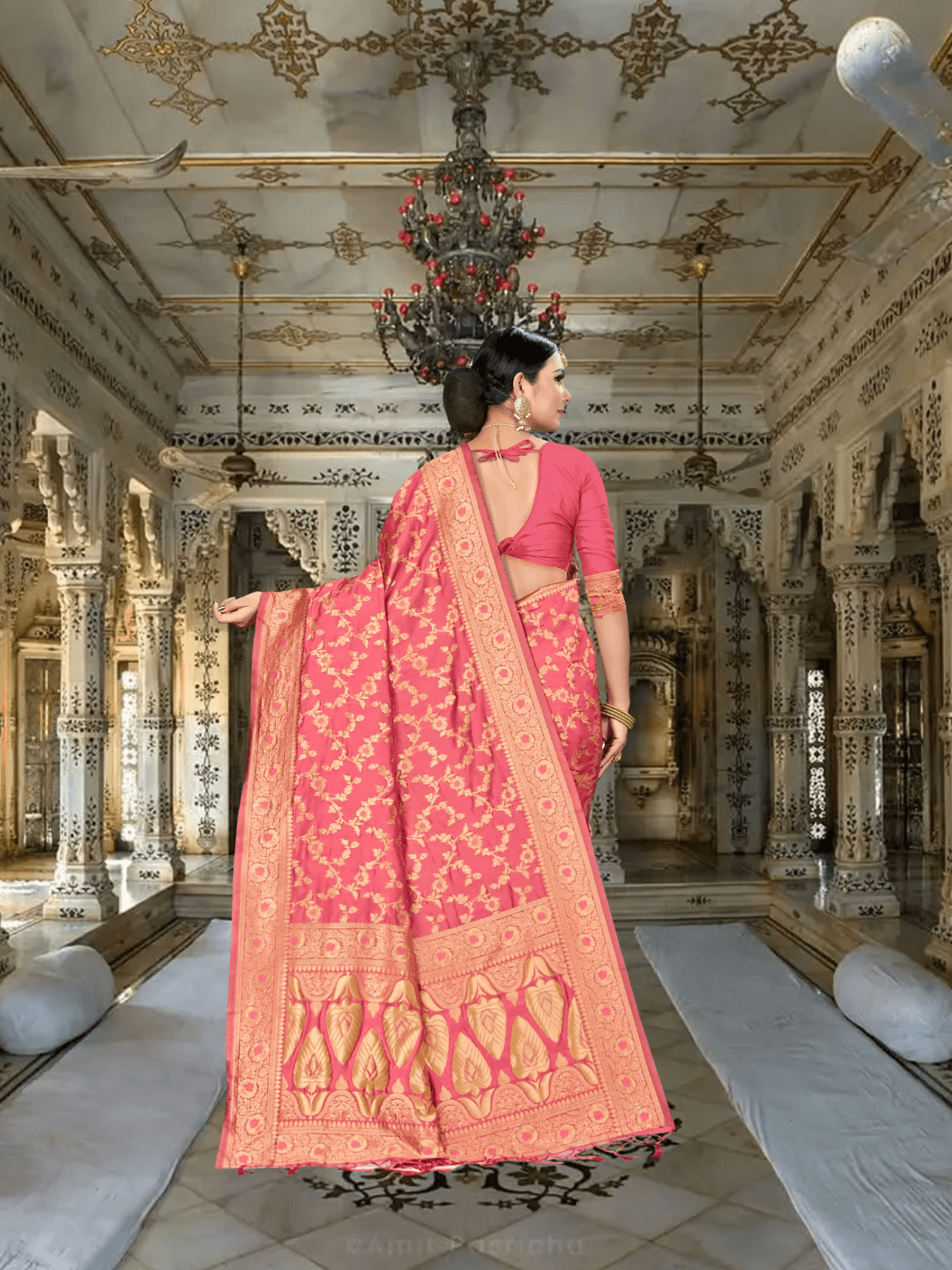 Gold-accented red saree pallu flowing in royal palace setting