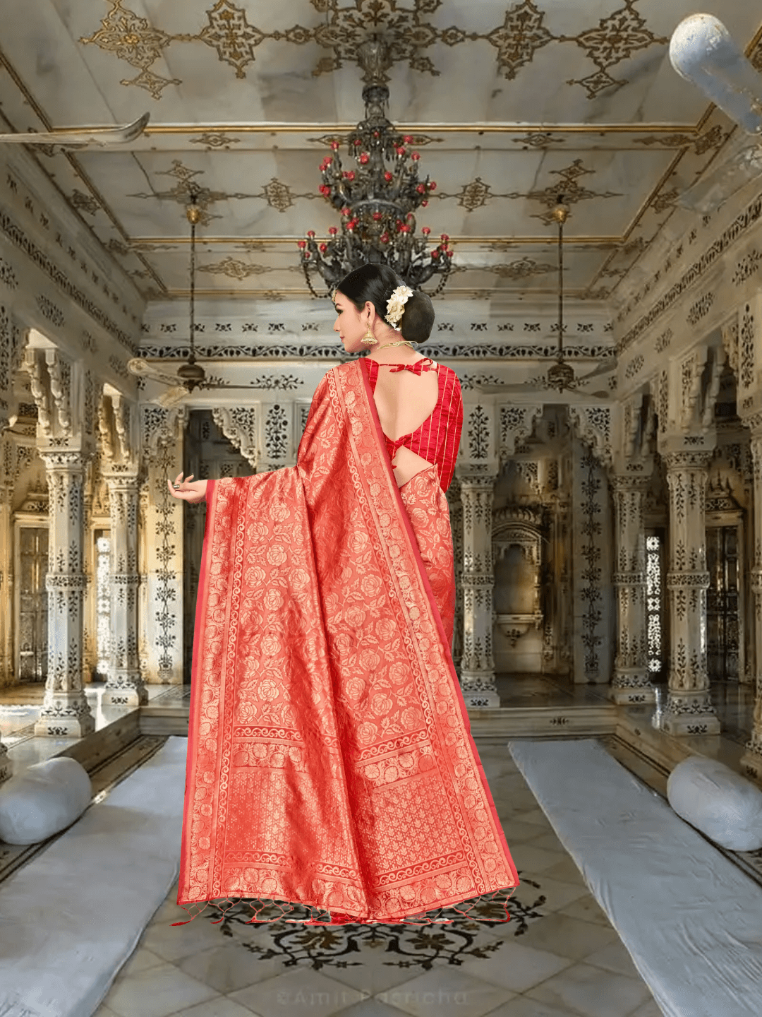 Red Banarasi saree with gold zari pallu displayed inside regal interior