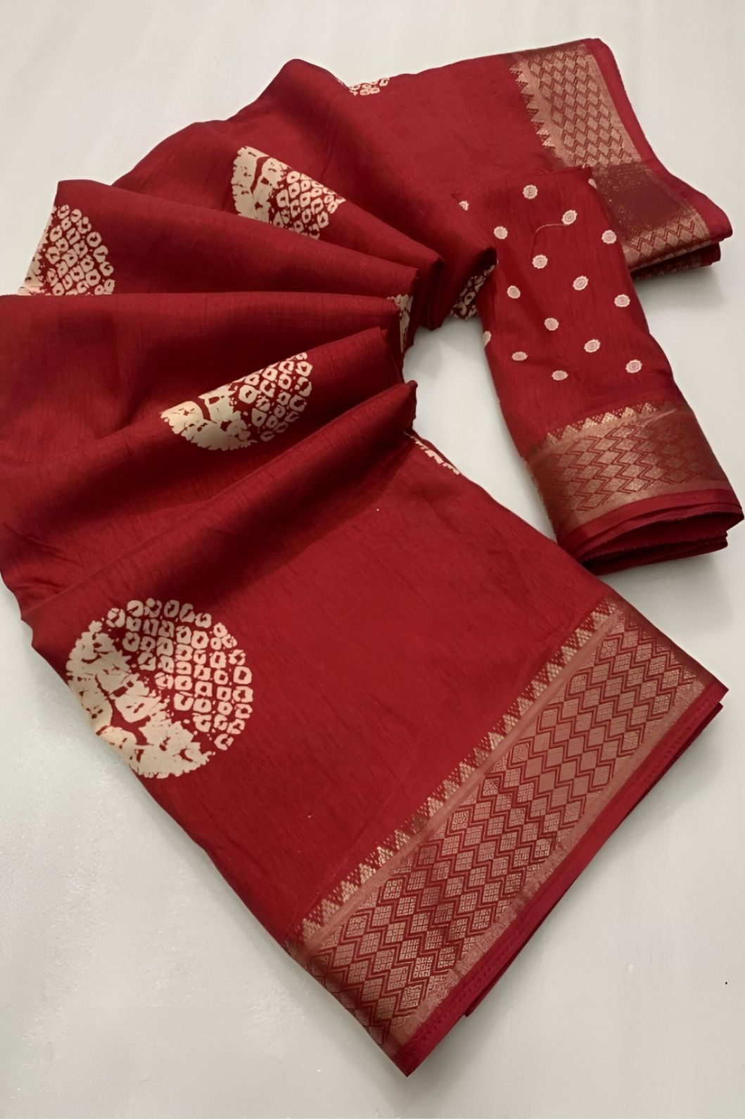 Closeup of red crape texture, intricate print and soft sheen