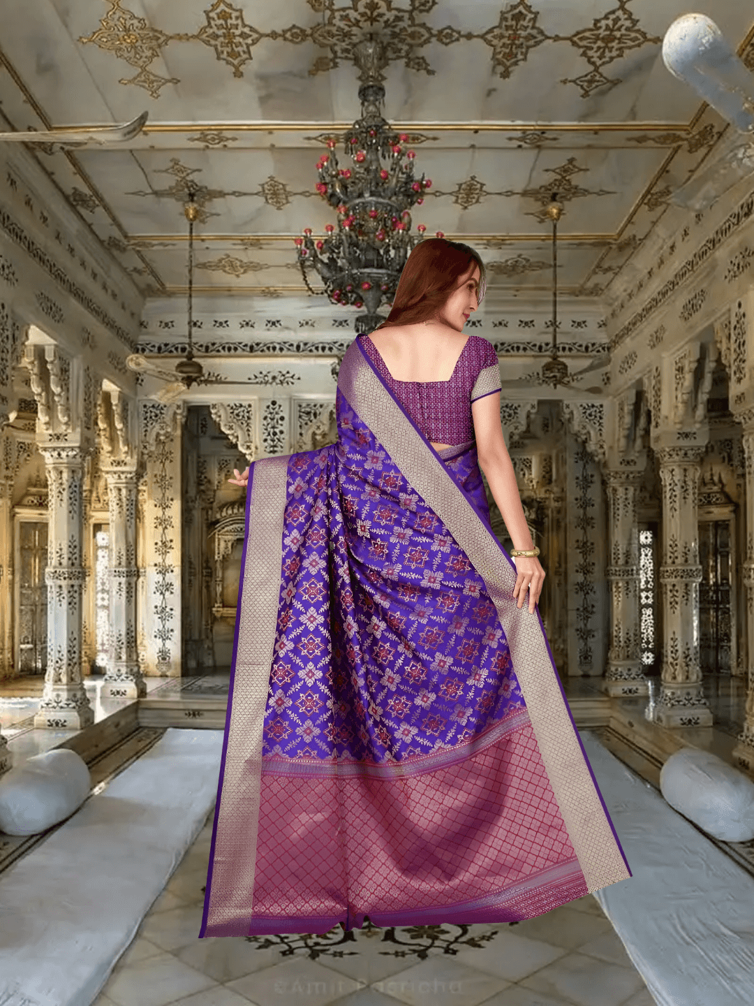 Side view of pallu showcasing gold borders and flower motifs in palace room