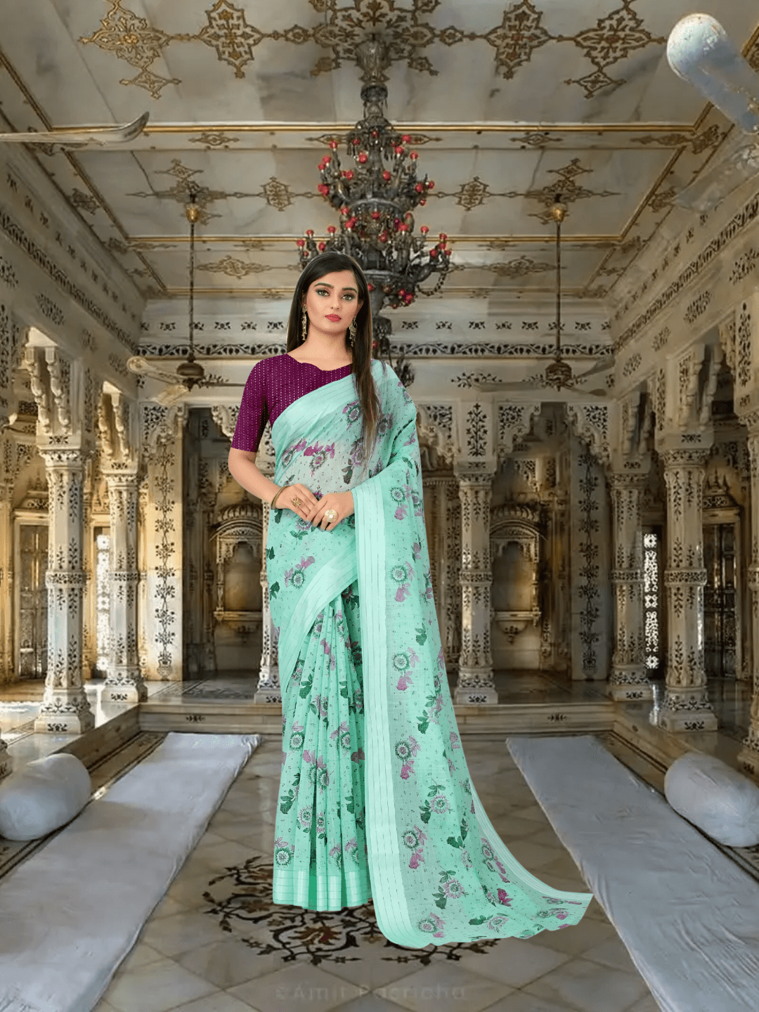 Model in light pista green cotton saree with floral prints, standing in regal palace room