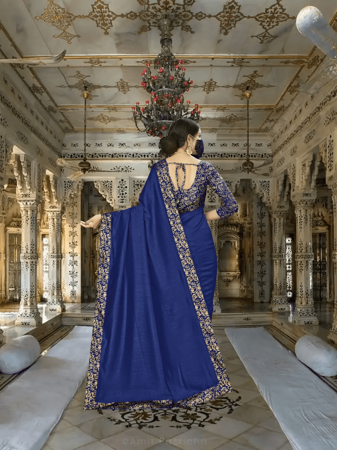 Sweeping pallu of digitally printed navy saree in royal setting