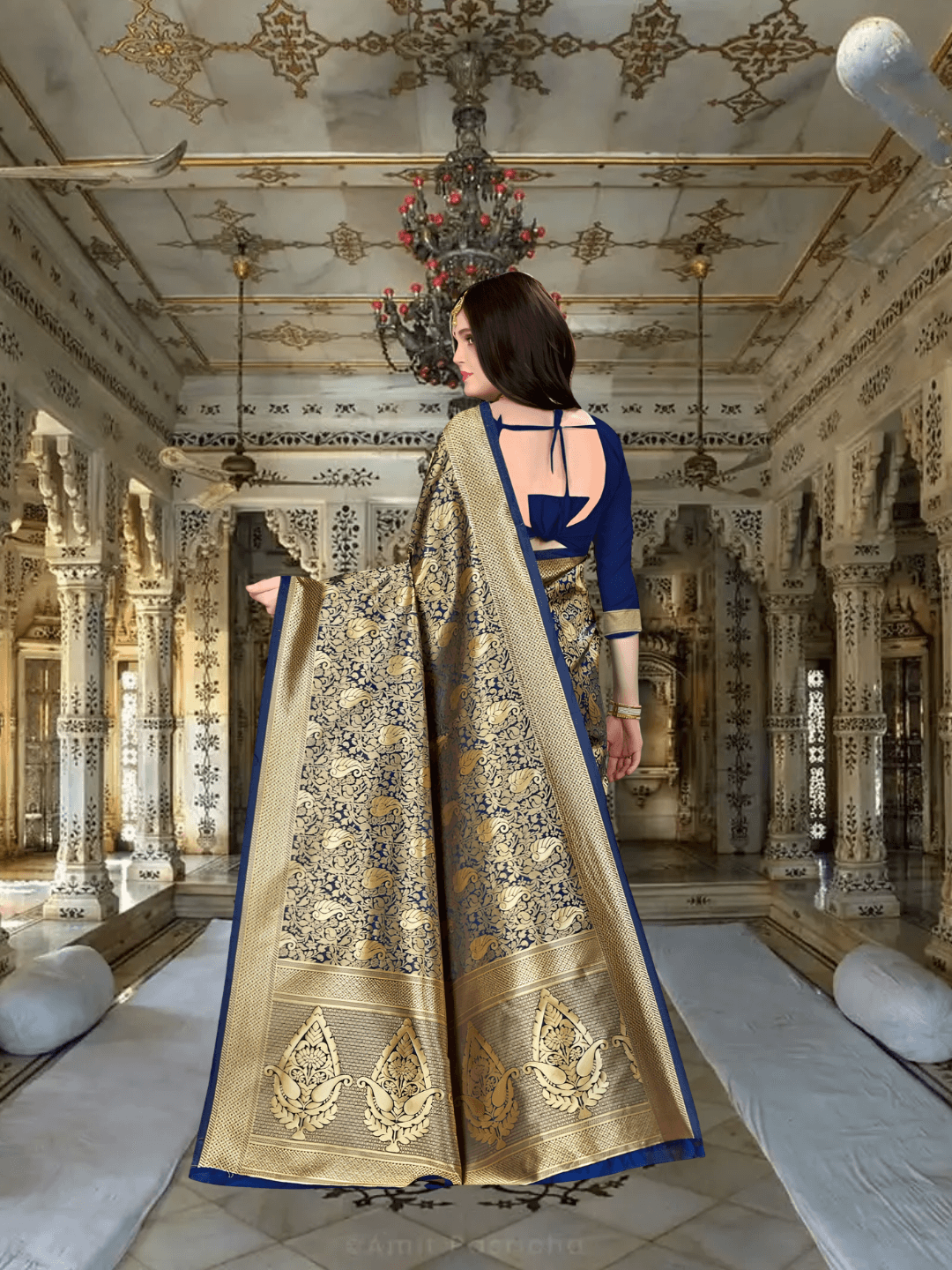 Elegant flow of gold pallu from blue silk saree in regal environment