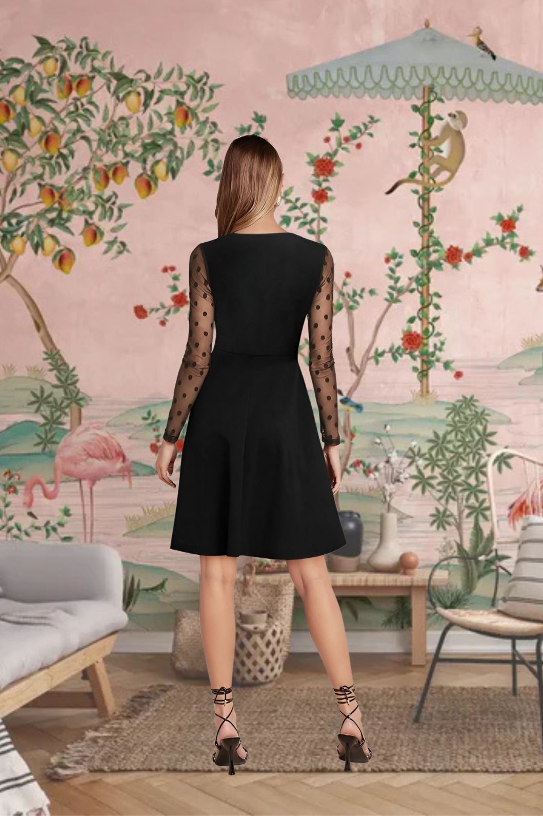 Back view of black dress showing soft fit and sheer shoulder detail