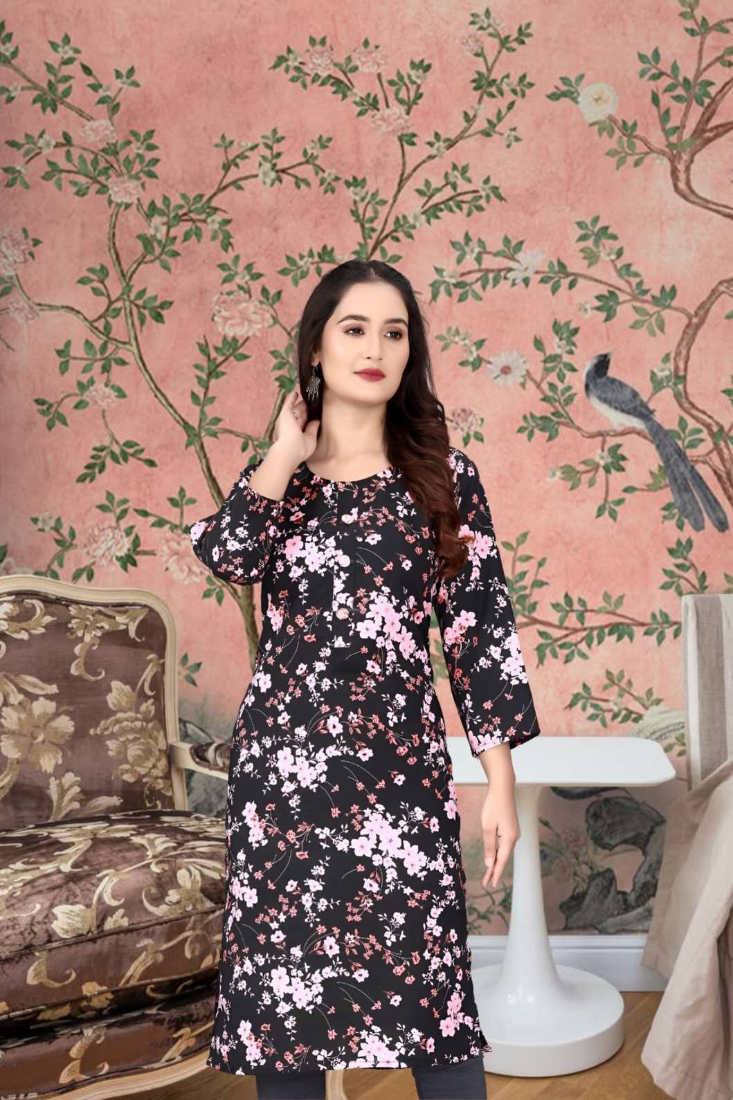 Front view of black kurti with floral print against moody studio wall