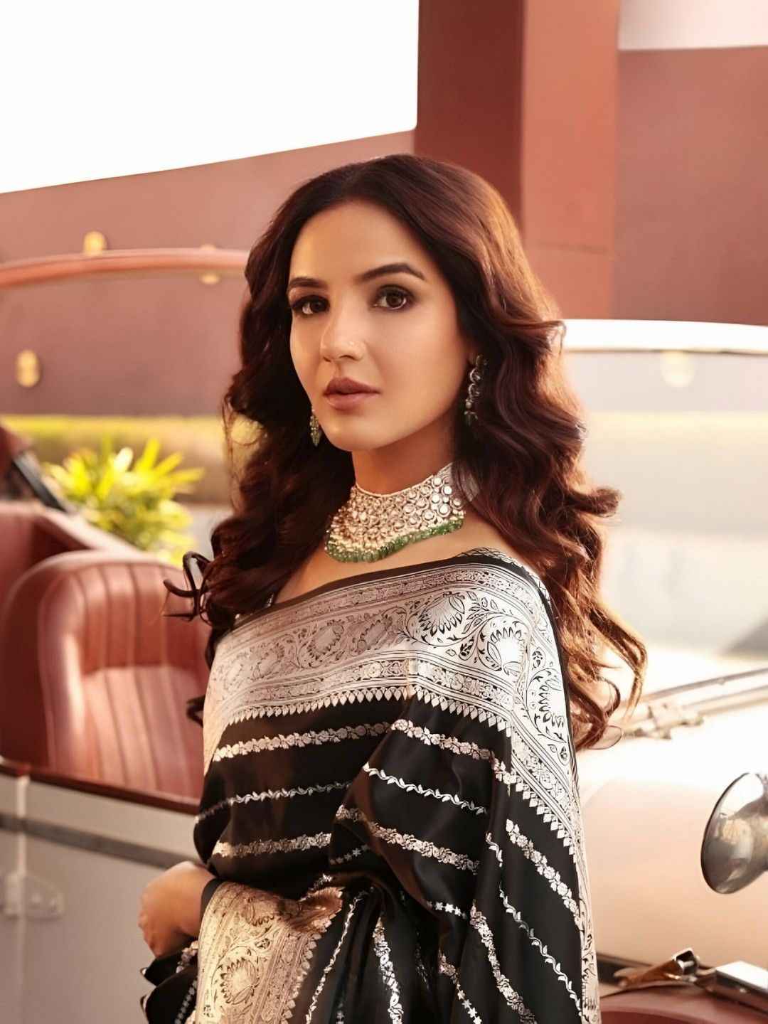 Model turning with flowing pallu and confident gaze