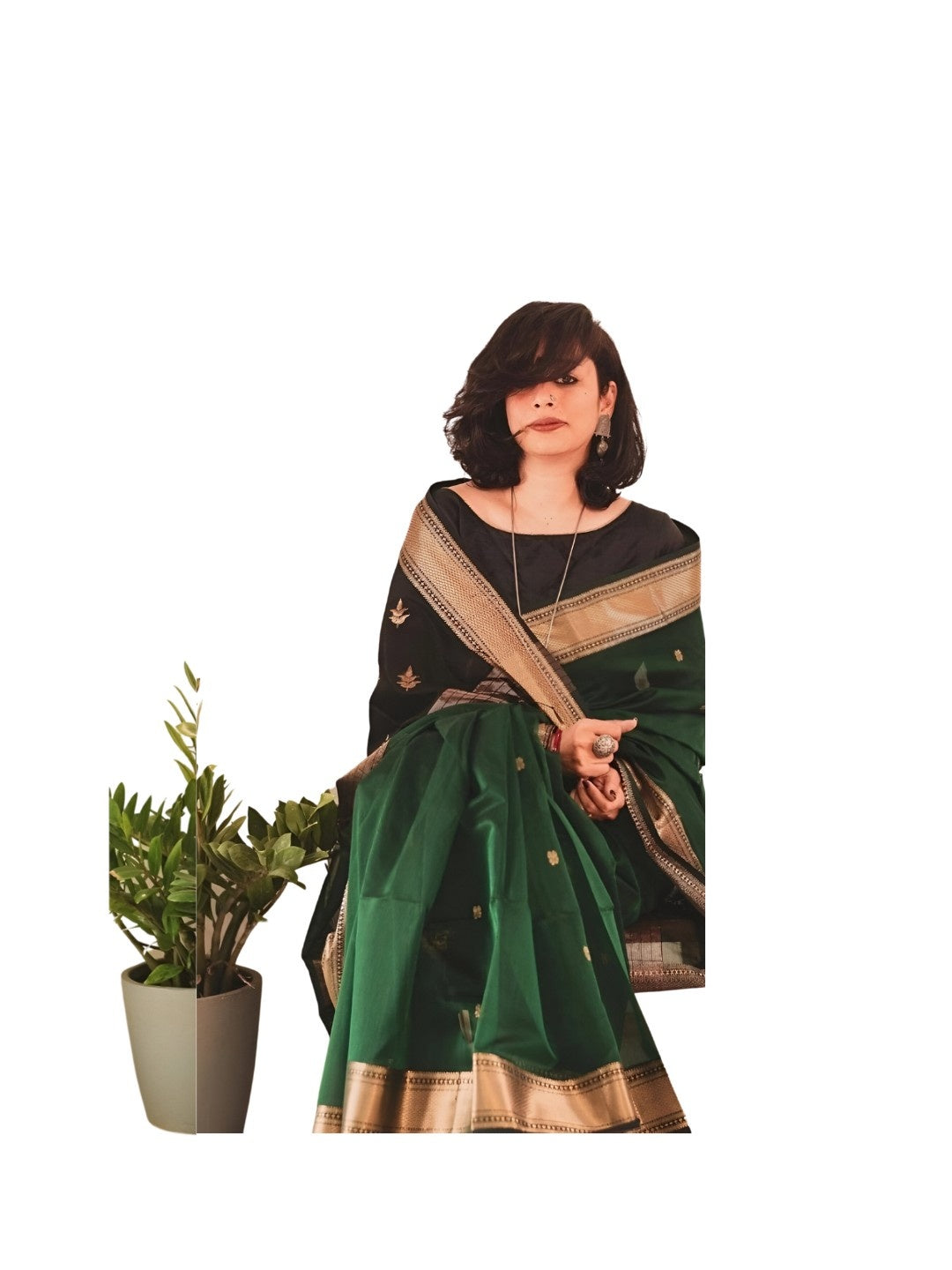 Model seated, hand resting on vintage chair