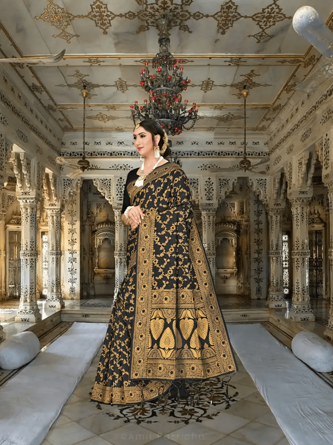 Black Banarasi saree draped elegantly, gold floral patterns glowing in soft light