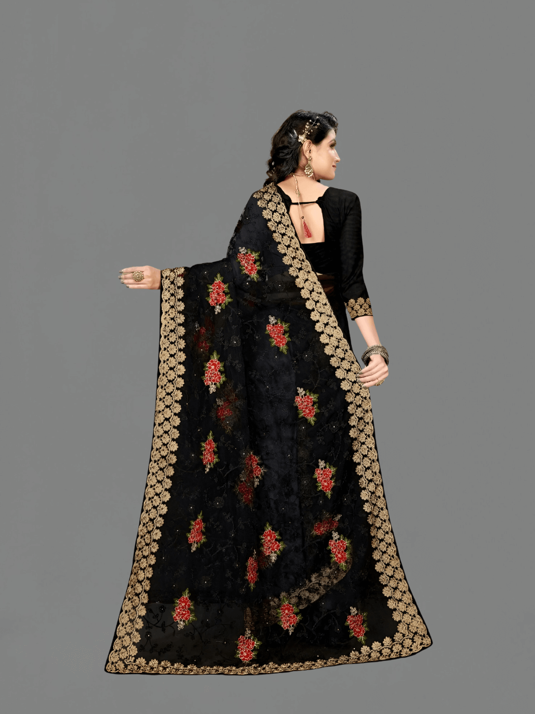 Flat lay of black net on grey slate, silver motifs placed like a jeweler’s sketch