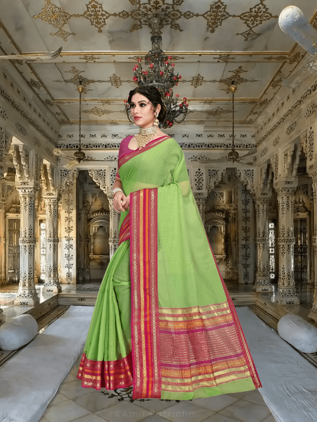 Back angle of pleats, blouse in bright pink balancing the earthy green saree