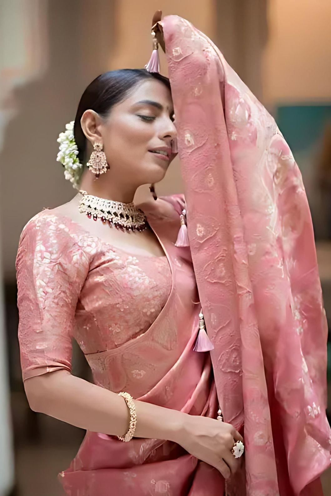 Studio close-up of peach embellished pallu in focus