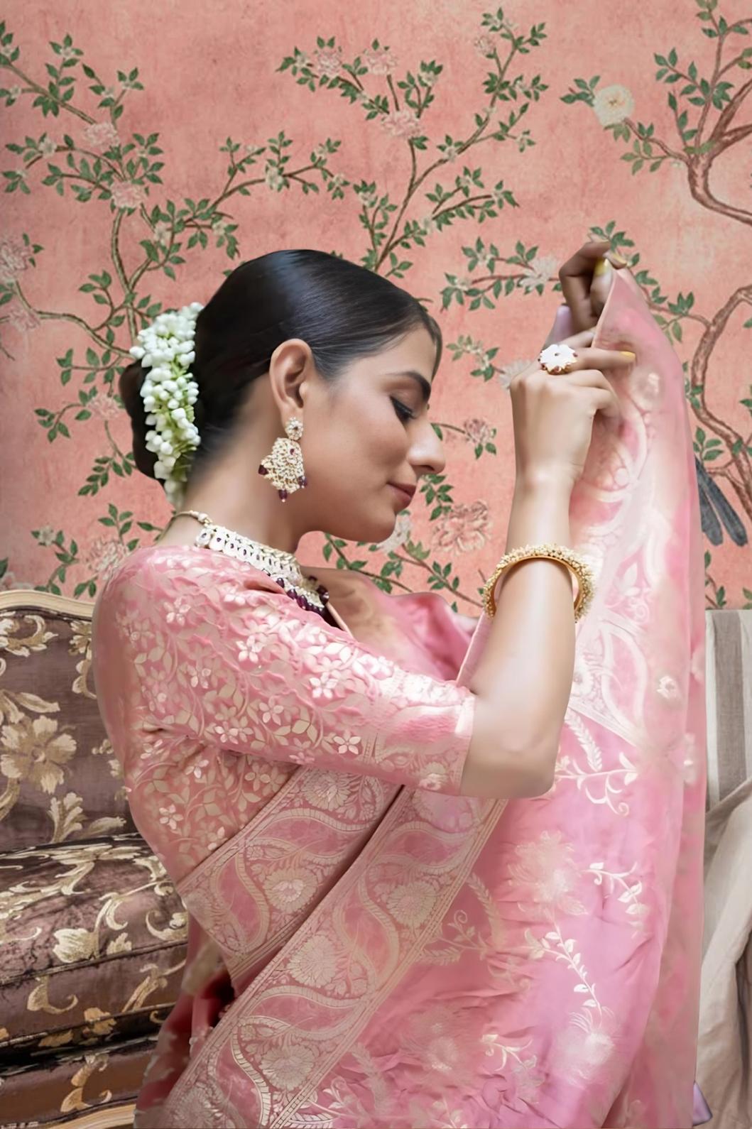 Studio close-up of peach embellished pallu in focus