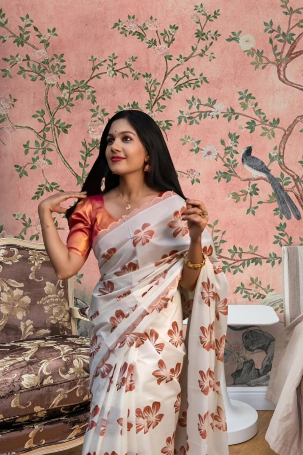 Front view of white-orange silk saree in a floral-themed palace backdrop