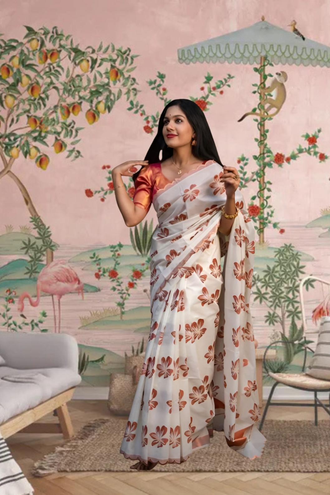 Front view of white-orange silk saree in a floral-themed palace backdrop