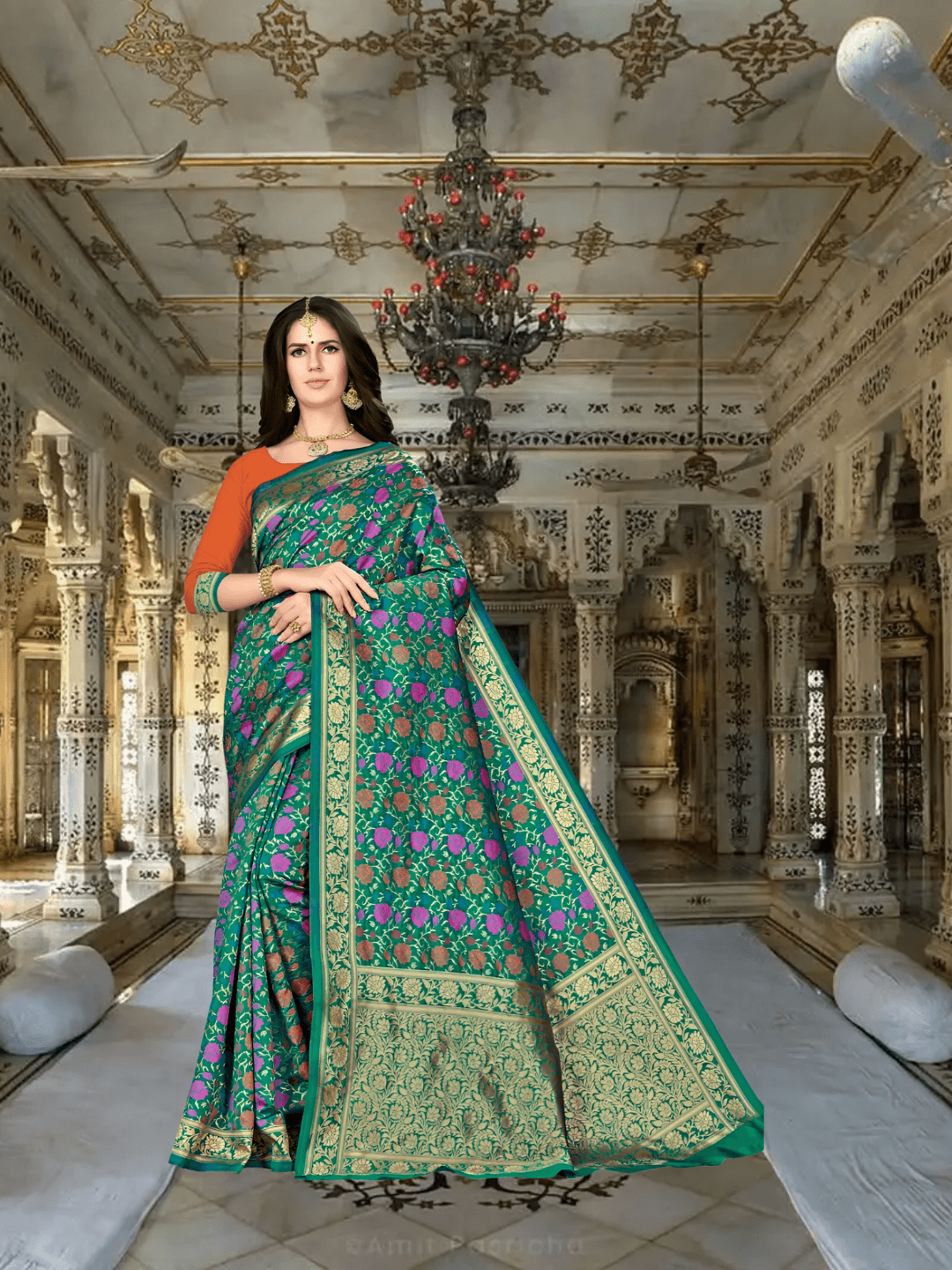 Close-up of pink floral designs on lush green Banarasi silk fabric