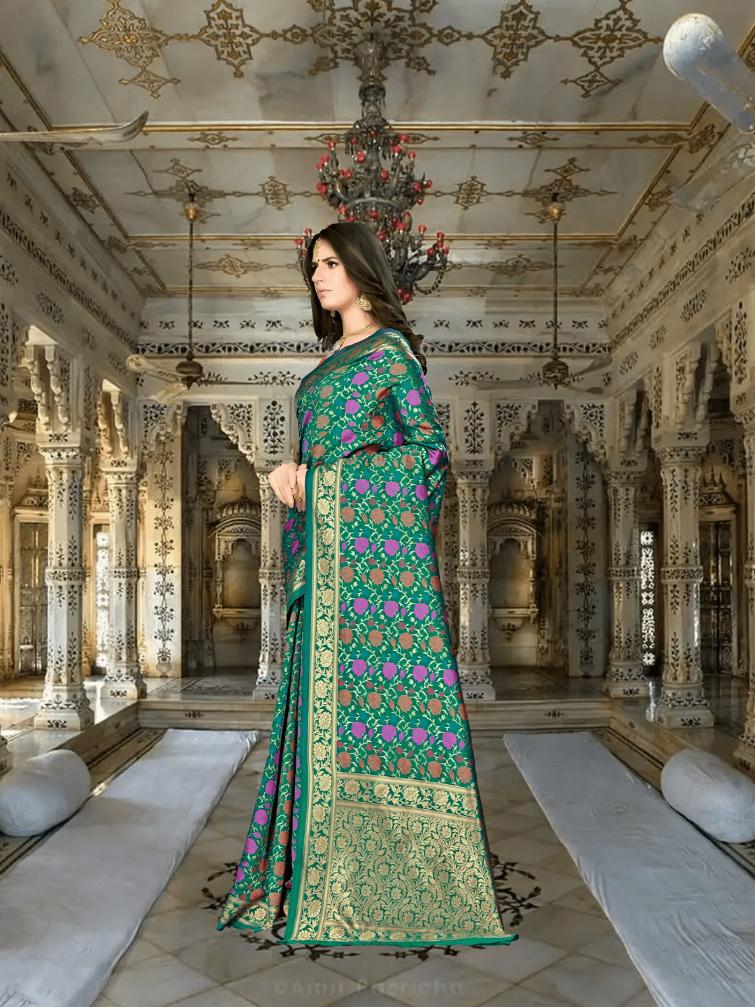 Model in green Banarasi saree with pink floral motifs in palace backdrop