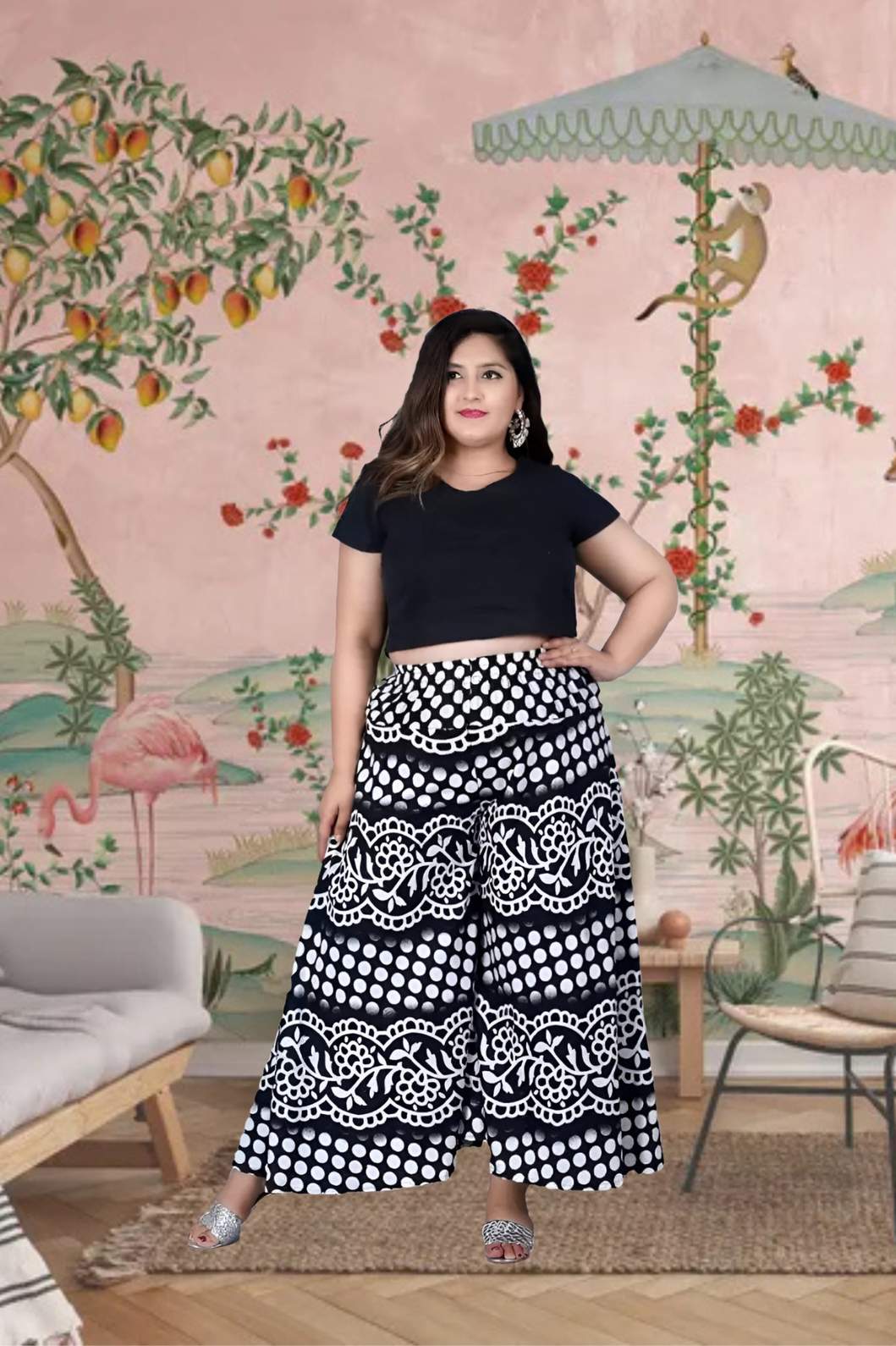 Front view of palazzo in soft black cotton, styled against stone pathway