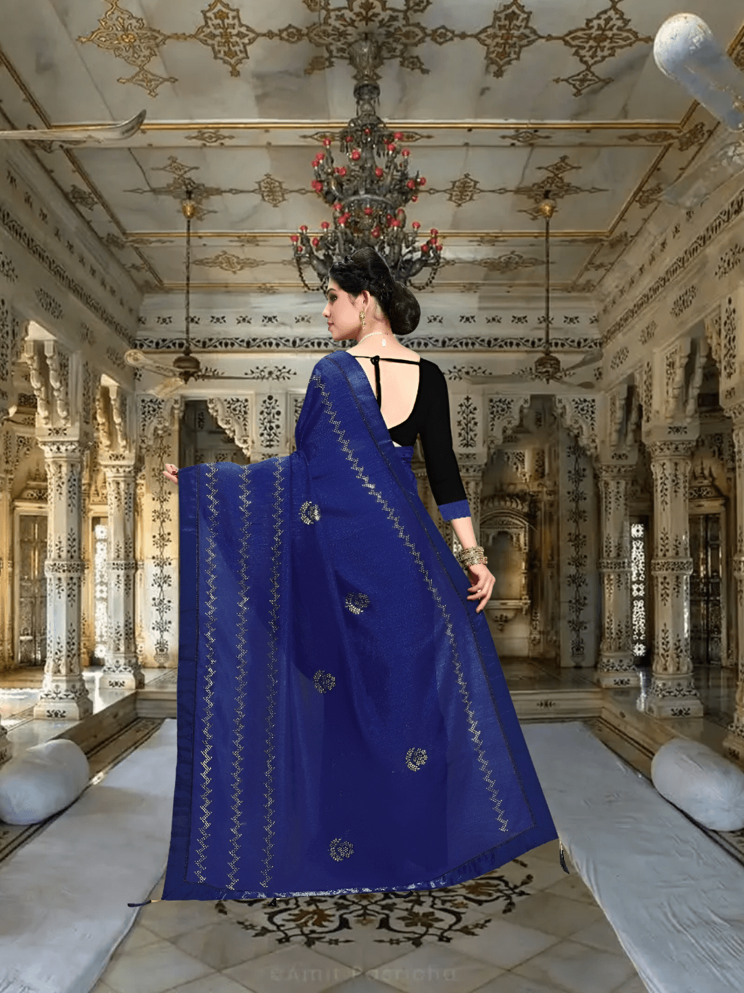 Back drape view of navy saree flowing softly in palace room setting